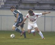 Austin's Martin Manocchio (right) battles for posession with Faribault's Ben Heppner during the Packers' 5-0 win over the Falcons at Art Hass Stadium Monday. Manocchio scored two goals in the win.